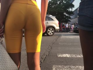 Black girl's thong is visible in orange shorts-4