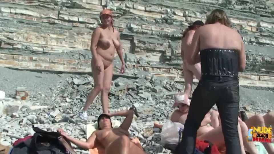 Real nudists sunbathe naked at nude beach