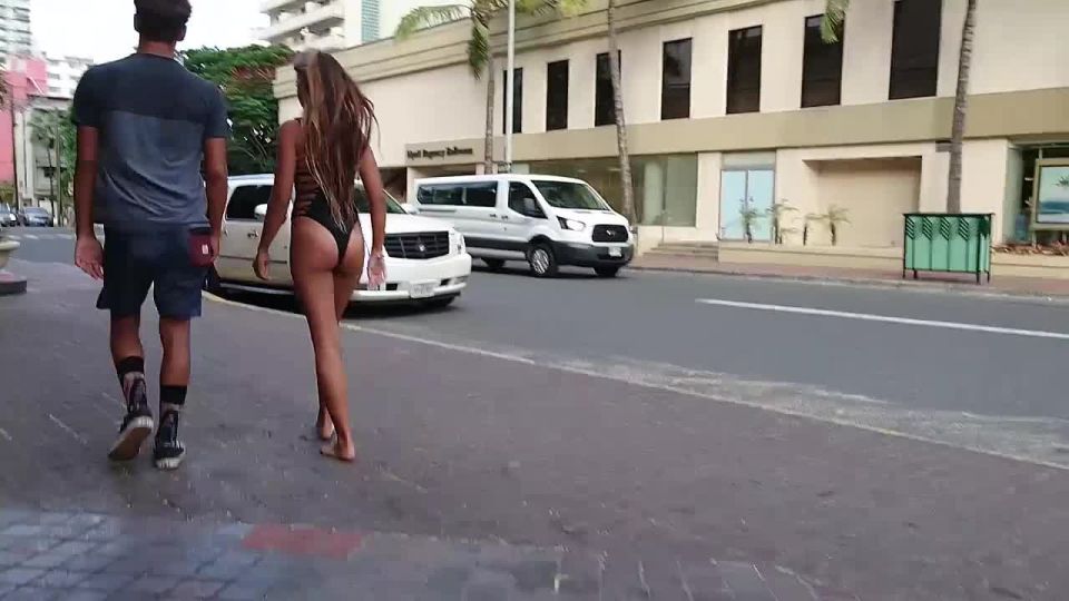 Sexy ass in swimsuit walks through street