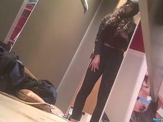 Teen tries pants in dressing  room-3