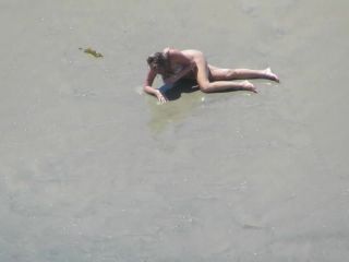 Wacky nudist woman rolls in the  mud-3