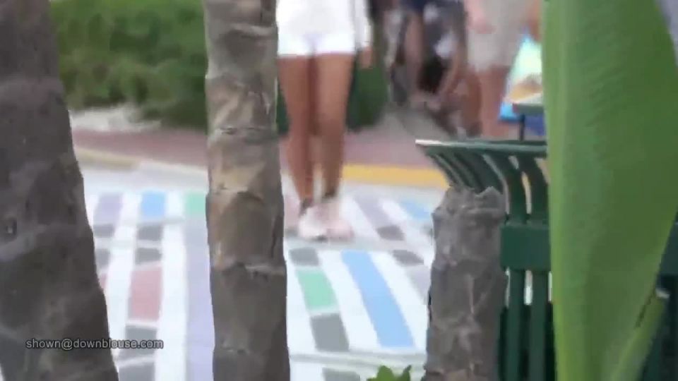 Two girls walking braless on teh street of Miami