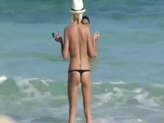 Skinny topless girl enters the water-0