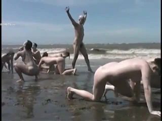 Bunch of nudists exercising on the  beach-4