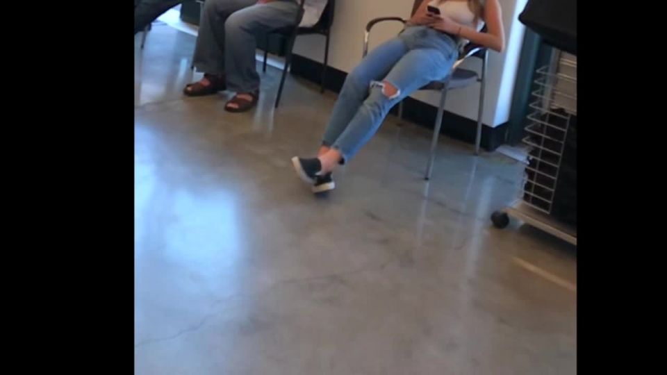 Beautiful tall girl looks bored in the waiting room