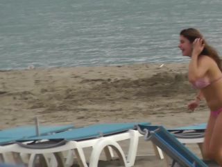 Cute girl chases friends on the beach-5