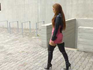 Thigh High Boots Outdoor. Hot redhead MILF in black thigh high spiked heel boots outdoor walking around and stopping to rub her boots and show them off in the best way possible-4