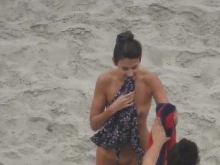 Beautiful woman gets dressed on beach-3